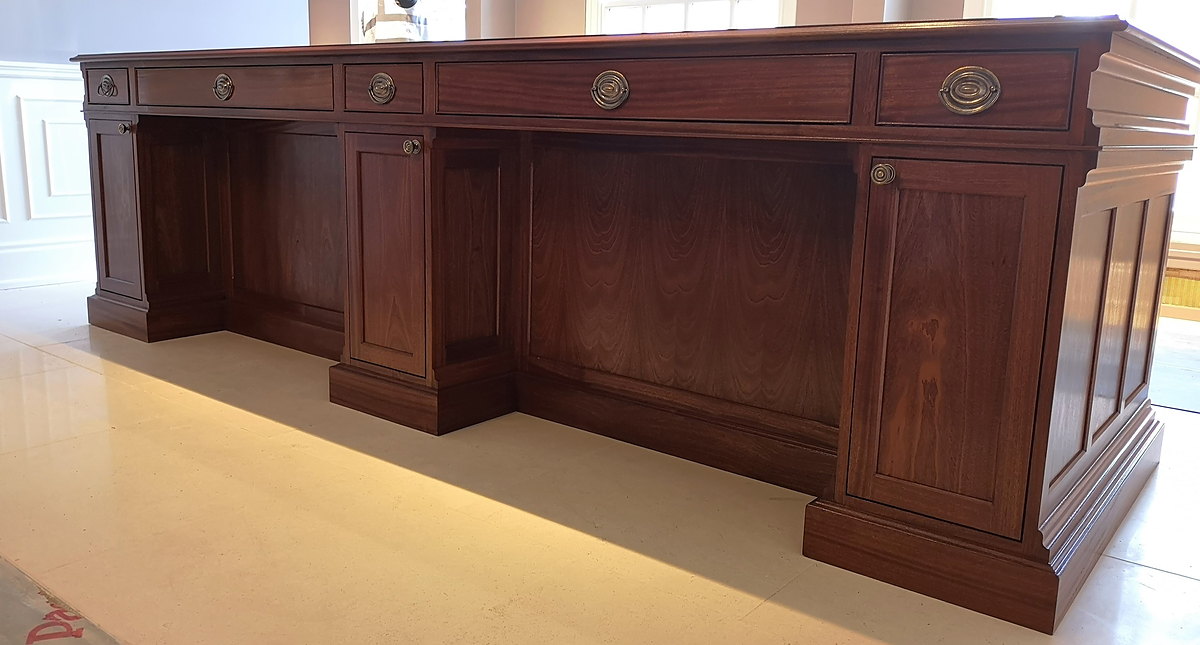 The drawer rail of the Chewton Glen reception desk with its brass ring pulls, and the bays beneath