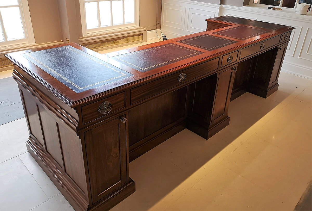 Three inset leather writing tops on the Chewton Glen reception desk, seen from above