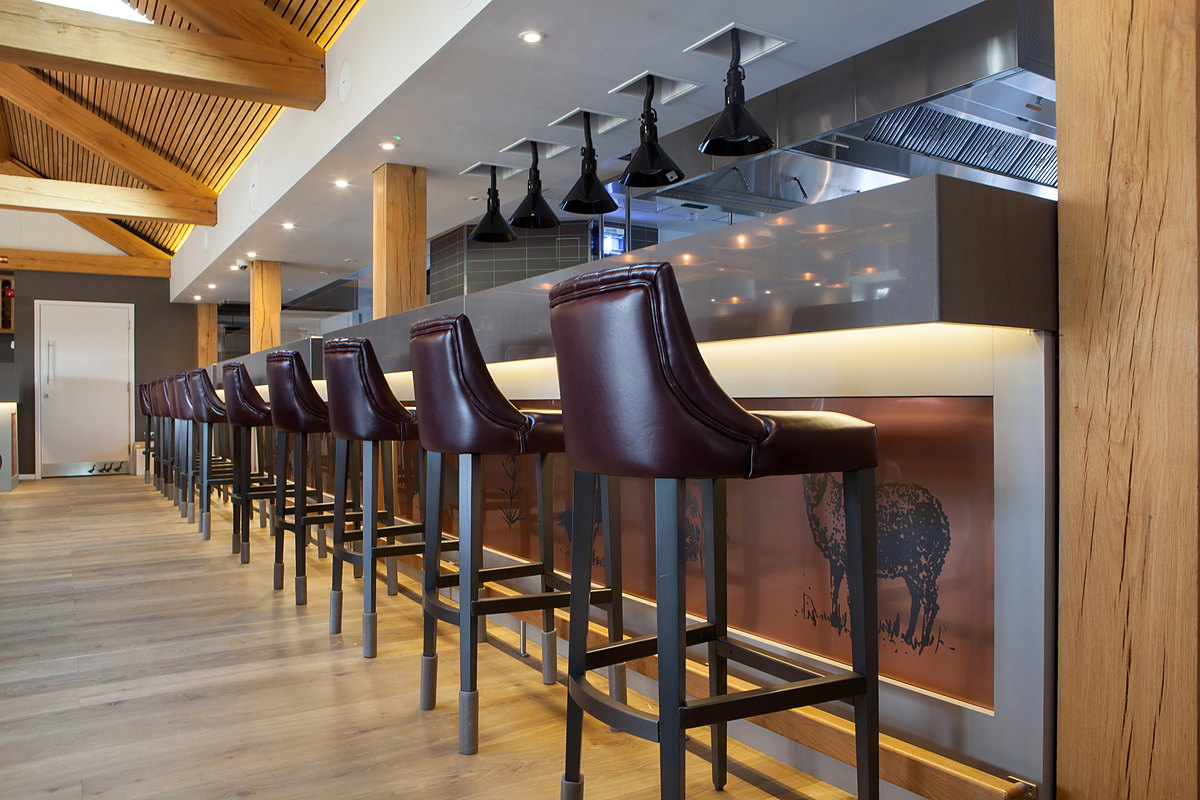 Leather bar stools along the counter of The Kitchen at Chewton Glen