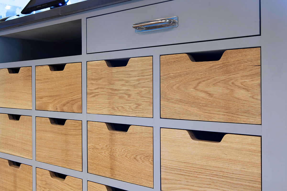 A bank of oak pigeon-hole drawers in a painted servery at The Kitchen, Chewton Glen