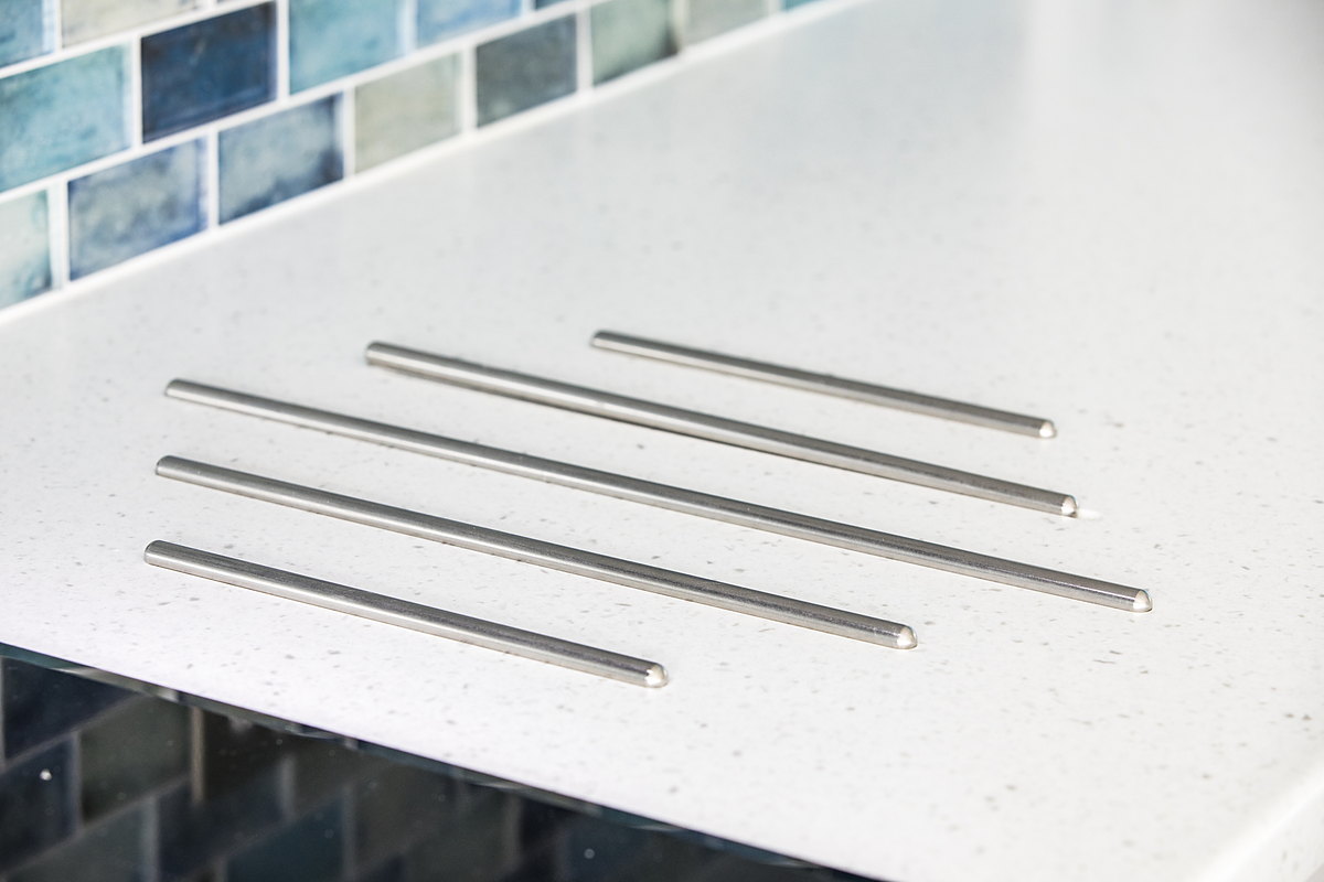 Drainer grooves routed directly into a seamless solid-surface worktop beside an integrated sink