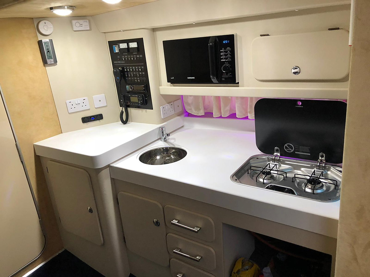A white solid-surface galley worktop aboard a Sunseeker yacht