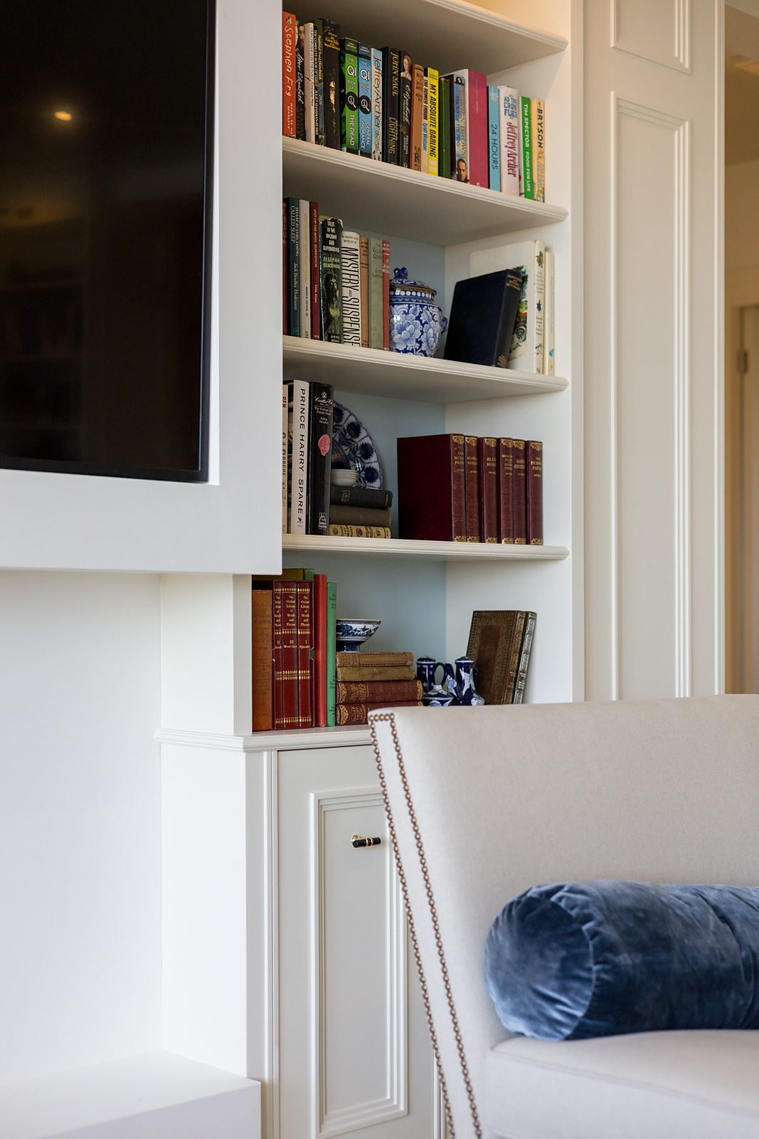 Fitted media wall framing a television within joinery