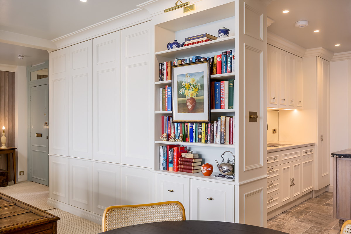 Painted library bookcase with a brass picture light