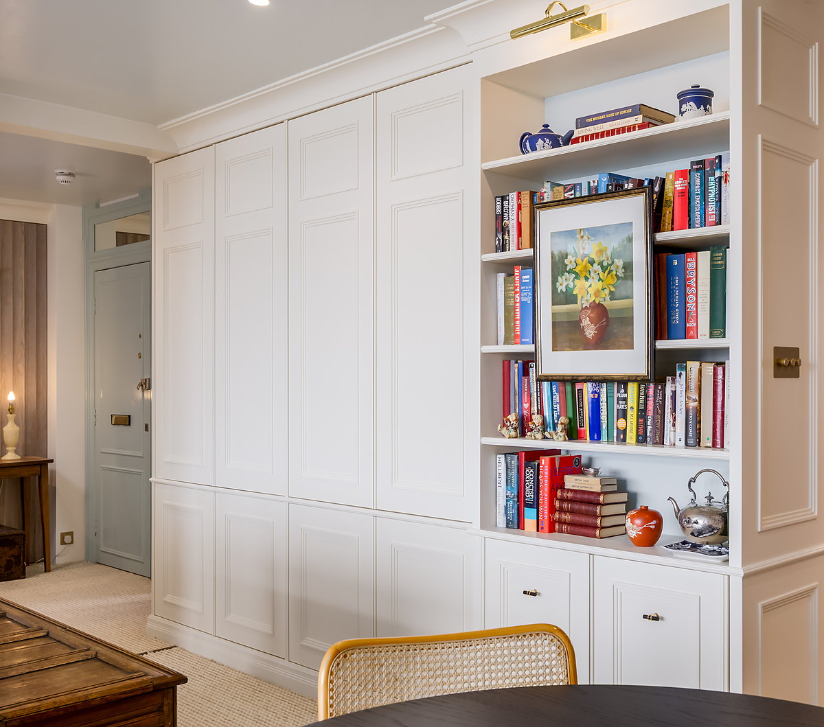 Painted library bookcase with a brass picture light