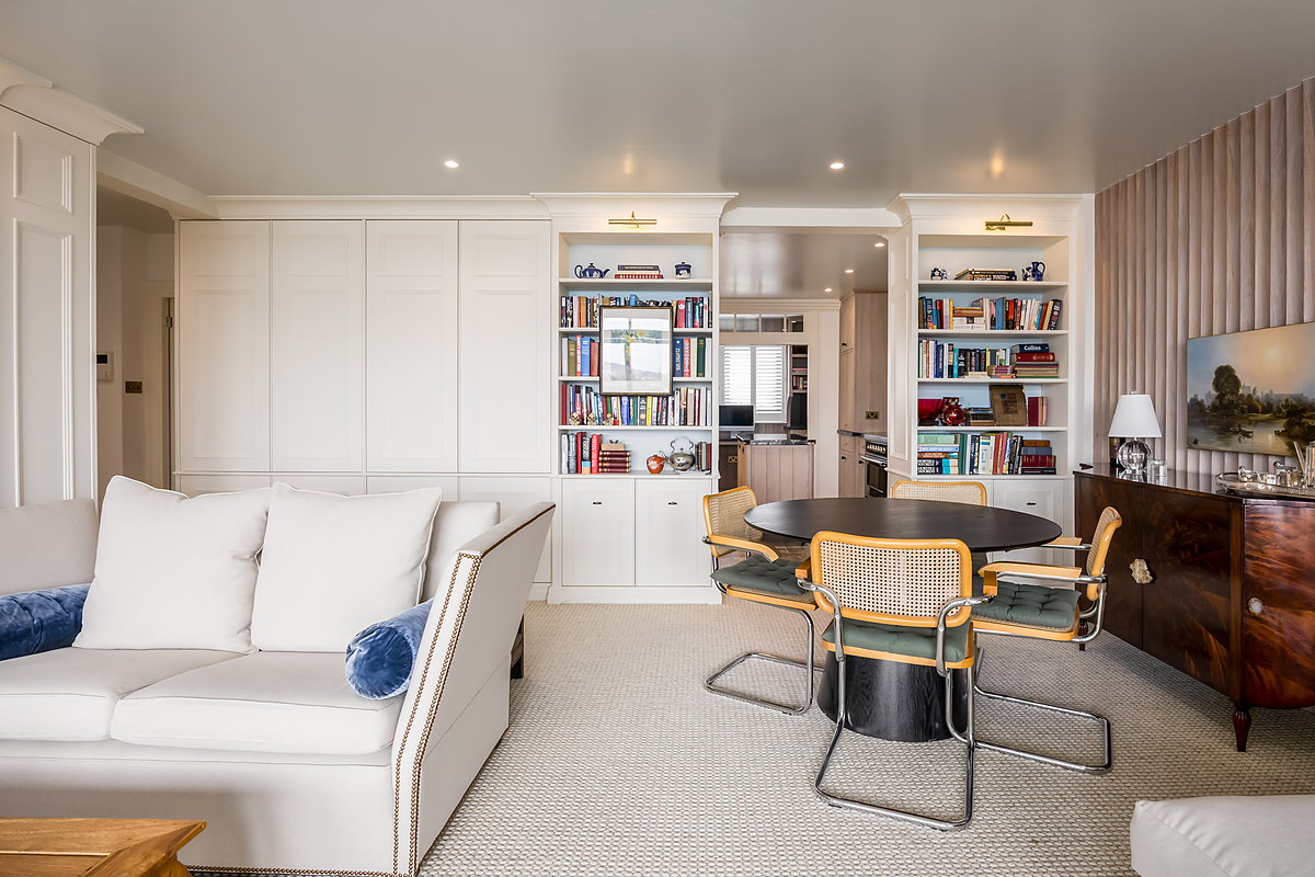 Panelled media wall with fitted bookcases and a fluted feature wall