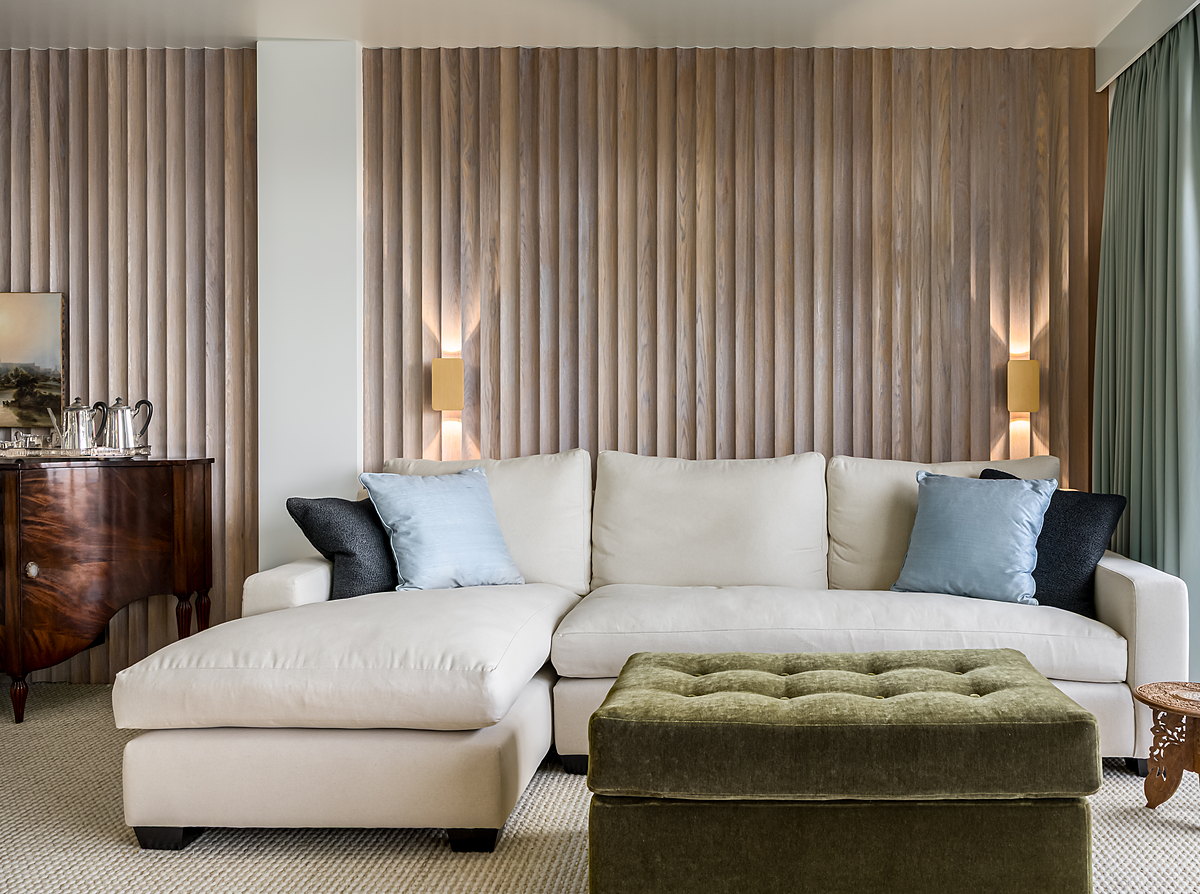 A full-height reeded timber wall in a drawing room