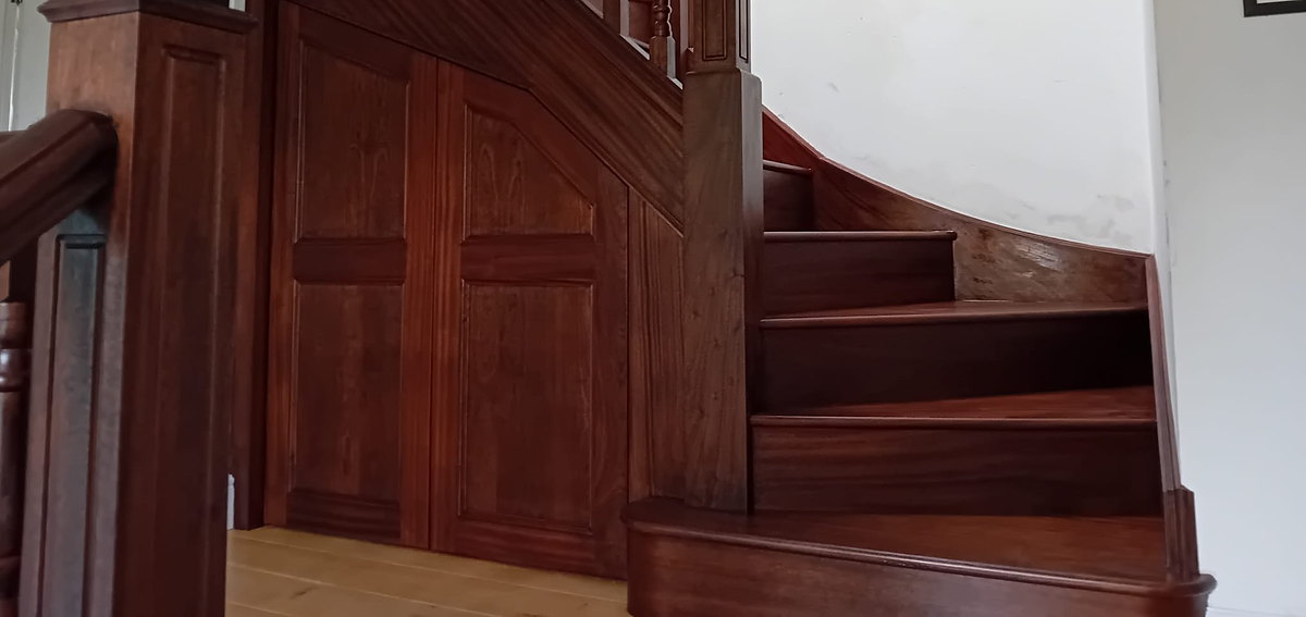 A bespoke mahogany staircase with turned spindles and fielded panelling